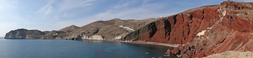 Red Beach and its red volcanic cliff on the south coast of Santorini